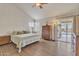 Main bedroom with wood floors, striped bedding, and sliding door to pool at 4028 N Ranier --, Mesa, AZ 85215