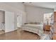 Main bedroom with wood floors, striped bedding, and ensuite bathroom access at 4028 N Ranier --, Mesa, AZ 85215