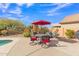 Inviting poolside patio area with table, chairs, and umbrella at 4028 N Ranier --, Mesa, AZ 85215