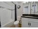 Well-lit bathroom with a shower-tub combo, tile backsplash and light neutral finishes at 4053 E Zion Way, Chandler, AZ 85249