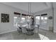 Dining area featuring a round wooden table, gray chairs, decor, and natural light at 4053 E Zion Way, Chandler, AZ 85249