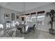 Bright dining area featuring a round wooden table, gray chairs, buffet, and natural light at 4053 E Zion Way, Chandler, AZ 85249