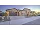 Stunning front exterior with desert landscaping, stone accents, gated entry, and three car garage at 4053 E Zion Way, Chandler, AZ 85249