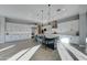 Spacious kitchen featuring white cabinets, a large island with seating, and stainless steel appliances at 4053 E Zion Way, Chandler, AZ 85249