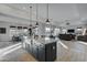 Open-concept kitchen with an island, modern pendant lights, and seamless flow to the dining and living spaces at 4053 E Zion Way, Chandler, AZ 85249