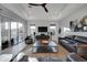 Living room with leather sofas, media center, stylish ceiling fan, and ample natural light at 4053 E Zion Way, Chandler, AZ 85249