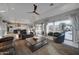 Bright living room featuring a ceiling fan, sliding glass doors and an open concept leading into the kitchen at 4053 E Zion Way, Chandler, AZ 85249