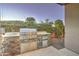 Built-in outdoor grill with stone facade, stainless steel appliances, and ample counter space for cooking at 4053 E Zion Way, Chandler, AZ 85249