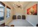 Sitting room with vintage record player, speakers, abstract wall art, and a window overlooking the yard at 4053 E Zion Way, Chandler, AZ 85249