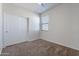 Spacious bedroom featuring a window with blinds and double closet at 41838 W Chatham Pl, Maricopa, AZ 85138