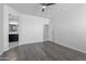 Large bedroom with grey wood-look floors and ceiling fan at 41838 W Chatham Pl, Maricopa, AZ 85138