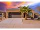 Tan house with a brown garage door and palm tree in the front yard at 41838 W Chatham Pl, Maricopa, AZ 85138