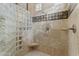 Bright bathroom with a glass block shower, built-in seat, and neutral tile at 4330 E Gemini Pl, Chandler, AZ 85249