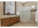 Elegant bathroom with glass shower, double sinks, and wooden vanity at 4330 E Gemini Pl, Chandler, AZ 85249