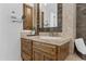 Modern bathroom with a single vanity, sleek sink, and wood cabinets at 4330 E Gemini Pl, Chandler, AZ 85249