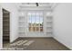 Bright bedroom with large window, built-in shelves, and plush carpet at 4330 E Gemini Pl, Chandler, AZ 85249