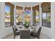 Bright breakfast nook with a round table and four chairs, offering a view of the backyard at 4330 E Gemini Pl, Chandler, AZ 85249