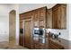 Kitchen with stainless steel appliances and custom wood cabinetry at 4330 E Gemini Pl, Chandler, AZ 85249