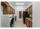 Laundry room with washer, dryer, and wood cabinets at 4330 E Gemini Pl, Chandler, AZ 85249