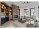 Spacious living room with a stone fireplace and built-in wooden shelving at 4330 E Gemini Pl, Chandler, AZ 85249