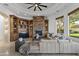 Bright living room with a stone fireplace, built-in shelving, and large windows at 4330 E Gemini Pl, Chandler, AZ 85249