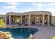 Relaxing kidney shaped pool with a rock waterfall feature and patio at 4330 E Gemini Pl, Chandler, AZ 85249