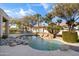 Inviting kidney shaped pool with a waterfall and plenty of rocks at 4330 E Gemini Pl, Chandler, AZ 85249