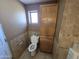 Small bathroom with toilet and wood cabinet at 4411 N 56Th Dr, Phoenix, AZ 85031