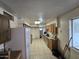 A galley kitchen with wood cabinets and tiled floor at 4411 N 56Th Dr, Phoenix, AZ 85031