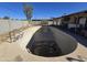 An oval swimming pool in need of cleaning at 4411 N 56Th Dr, Phoenix, AZ 85031