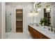 Chic bathroom with a double sink vanity, walk-in shower, and access to a walk-in closet at 4420 E Glenrosa Ave, Phoenix, AZ 85018