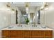 Elegant bathroom featuring a double vanity with stylish fixtures, a large mirror, and a walk-in shower at 4420 E Glenrosa Ave, Phoenix, AZ 85018