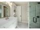 Elegant bathroom with dual vanities, marble countertops, gold fixtures, and a glass-enclosed shower at 4420 E Glenrosa Ave, Phoenix, AZ 85018