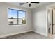 Inviting bedroom with a large window, ceiling fan, and access to a private bathroom at 4420 E Glenrosa Ave, Phoenix, AZ 85018