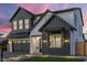 Modern farmhouse with a manicured green lawn and a combination of gray paint and black trim at 4420 E Glenrosa Ave, Phoenix, AZ 85018