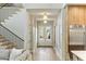 Bright and airy foyer features wood floors, a modern staircase, and glass front doors at 4420 E Glenrosa Ave, Phoenix, AZ 85018