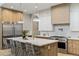 Modern kitchen featuring stainless steel appliances, a large island with seating, and light fixtures at 4420 E Glenrosa Ave, Phoenix, AZ 85018