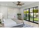 Light-filled main bedroom with sliding glass doors to the backyard, modern furnishings, and stylish decor at 4420 E Glenrosa Ave, Phoenix, AZ 85018