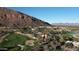 Scenic aerial view of the property with a picturesque mountain backdrop, resort, and golf course at 4575 N Phoenician Blvd # 2, Scottsdale, AZ 85251