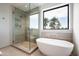 Spa-like bathroom with walk-in shower, soaking tub, and scenic outdoor views at 4575 N Phoenician Blvd # 2, Scottsdale, AZ 85251