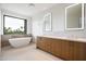Well-lit bathroom features a soaking tub, double vanity, and a scenic outdoor view at 4575 N Phoenician Blvd # 2, Scottsdale, AZ 85251