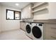 Bright laundry room features front loading washer/dryer and ample cabinet and counter space at 4575 N Phoenician Blvd # 2, Scottsdale, AZ 85251
