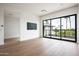 Bright living room features beautiful hardwood floors and large windows at 4575 N Phoenician Blvd # 2, Scottsdale, AZ 85251