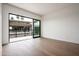 Bright bedroom featuring hardwood floors and sliding doors with a private balcony at 4575 N Phoenician Blvd # 4, Scottsdale, AZ 85251