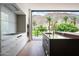 Bright kitchen featuring white cabinets, a dark island and views of the outdoor landscaping and mountains at 4575 N Phoenician Blvd # 4, Scottsdale, AZ 85251