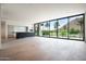 Bright living space with walls of windows offering stunning views and an adjacent sleek kitchen at 4575 N Phoenician Blvd # 4, Scottsdale, AZ 85251