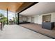 Indoor/outdoor living with sliding doors leading to a patio with a grill and views to living space at 4575 N Phoenician Blvd # 4, Scottsdale, AZ 85251
