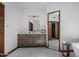 Bathroom with gray wood vanity and a large mirror at 4920 E Beryl Ave, Paradise Valley, AZ 85253