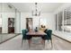 Elegant dining room with a modern chandelier and green chairs at 4920 E Beryl Ave, Paradise Valley, AZ 85253