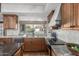 Kitchen with granite countertops, wood cabinets, and a view of the backyard at 4920 E Beryl Ave, Paradise Valley, AZ 85253